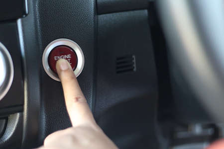 Finger pressing the button start engine in a carの写真素材