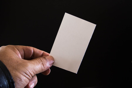 The man is holding a blank paper の写真素材