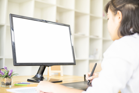 Graphic designer using graphics tablet and computer in the office, with soft focus, vintage toneの写真素材