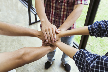 people showing unity with their hands together, teamwork and together concept, soft focus, vintage...