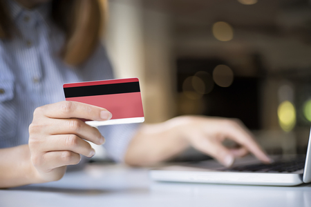 woman shopping online with laptop and credit card, sale and shopping online concept, soft focusの写真素材
