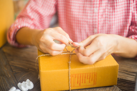 happy women packaging product for online business in home, online business concept, business owner...