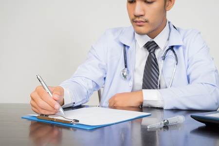 medical doctor working with laptop computer on white background, medical conceptの写真素材
