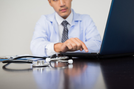 medical doctor working with laptop computer on white background, medical conceptの写真素材