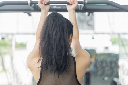 Fitness woman in training showing exercises with exercise-machine in gym, fitness concept, sport conceptの写真素材