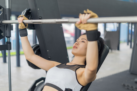 Fitness woman in training showing exercises with barbells in gym, fitness concept, sport conceptのeditorial素材