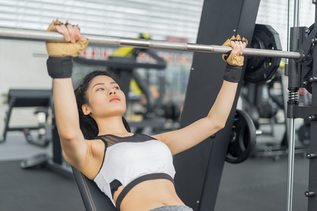 Fitness woman in training showing exercises with barbells in gym, fitness concept, sport conceptのeditorial素材