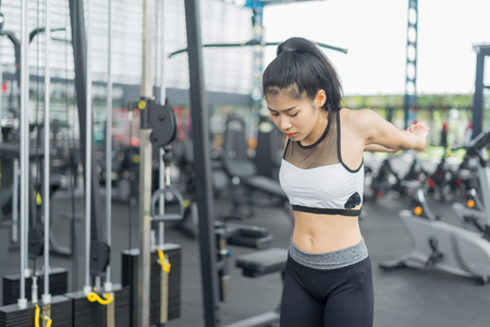 Fitness woman warming and stretching in gym, sport conceptのeditorial素材