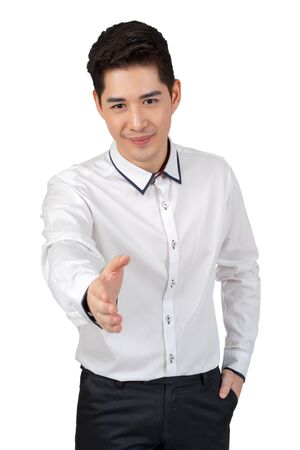 Happy young businessman in suit looking at camera on white background, isolated conceptの写真素材