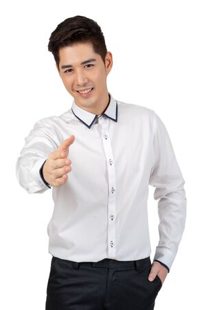 Happy young businessman in suit looking at camera on white background, isolated conceptの写真素材
