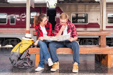 Young traveling backpacker on vacation at the train station, travel conceptの写真素材