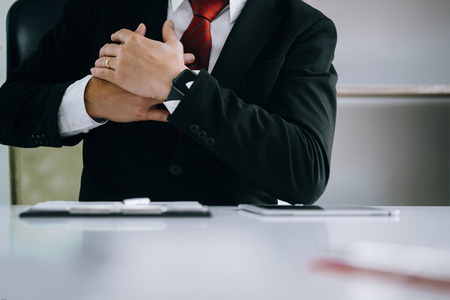 Businessman feel pain in their heart while working in the office, medical conceptの写真素材