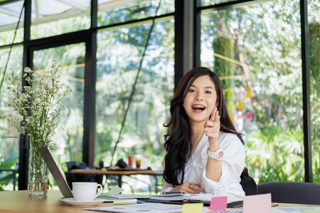 young businesswoman working with mobile laptop and documents in office, business conceptの写真素材