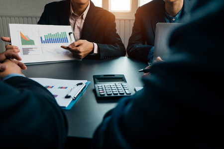 Businesspeople analyzing investment graph meeting brainstorming and discussing plan in meeting room, investment conceptの写真素材
