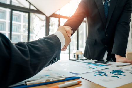 Businesspeople partners shaking hands after complete agreement plan in meeting room, investment concept, success concept