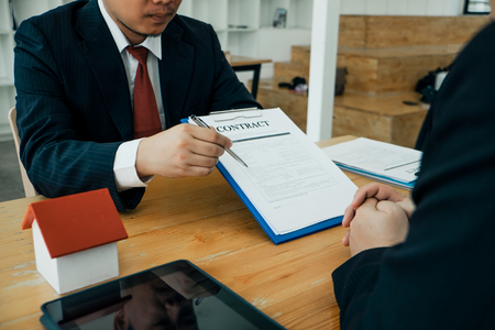 Real estate agents submit documents for customers to sign for a sale contract,real estate conceptの写真素材
