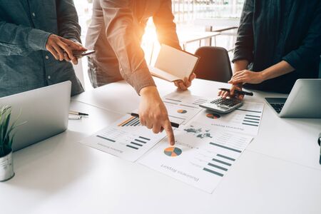 Business people analyzing investment graph meeting brainstorming and discussing plan in meeting room, investment conceptの写真素材