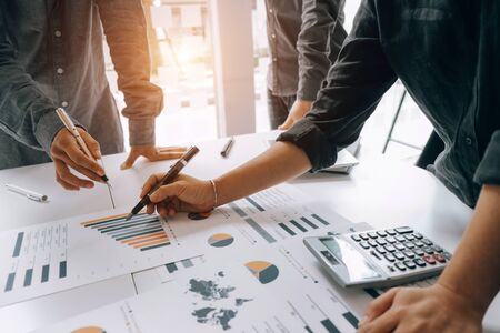 Business people analyzing investment graph meeting brainstorming and discussing plan in meeting...