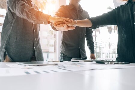 Businesspeople teamwork group putting their hands together agreement plan in meeting room, investment concept, success conceptの写真素材