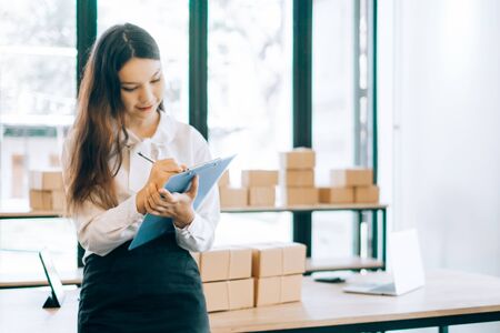 happy women checking order online business with laptop in home, online business concept, business online conceptの写真素材