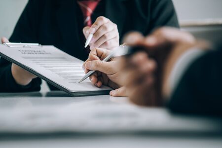 Real estate agents submit documents for customers to sign for a sale contract,real estate concept.の写真素材