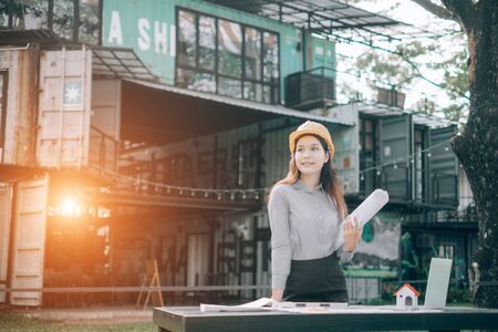 young engineers wearing helmat looking up outside the office, Engineer conceptの写真素材