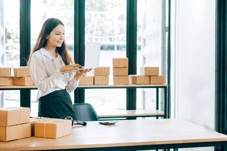 happy women checking order online business with laptop in home, online business concept, business online conceptの写真素材