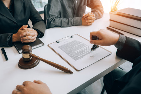 smart lawyer holding stamp for submit documents  with advice in the office before considering the judgment, lawyer conceptの写真素材