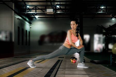 sport woman at fitness gym club warm-up and stretch body before doing exercise, fitness concept, sport conceptの写真素材