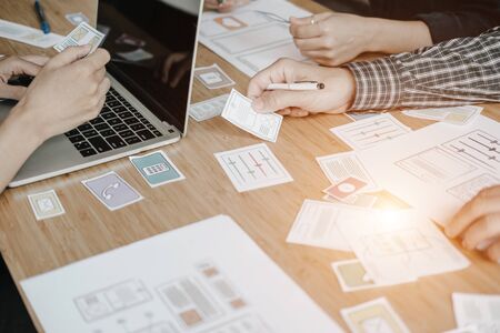 Graphic designers work together with computer designing application for mobile phone, Graphic designers conceptの写真素材