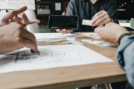 Graphic designers work together with computer designing application for mobile phone, Graphic designers conceptの写真素材