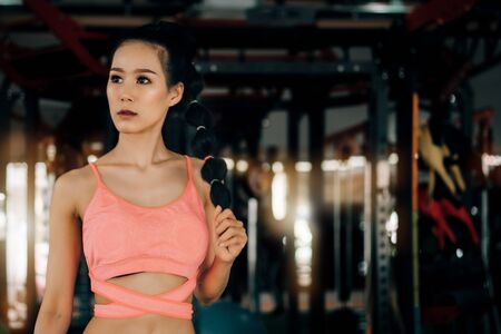 sport woman at fitness gym club doing exercise for arms with kettlebell and showing muscle bodybuilding, fitness concept, sport conceptの写真素材
