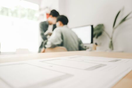 Graphic designers work together with computer designing application for mobile phone, Graphic...