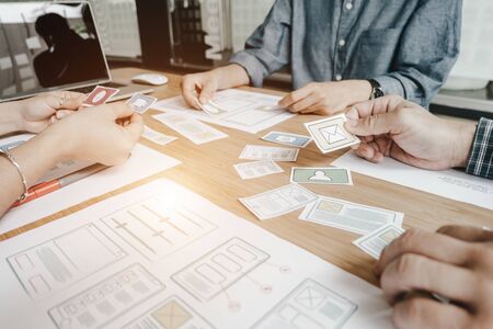 Graphic designers work together with computer designing application for mobile phone, Graphic designers conceptの写真素材