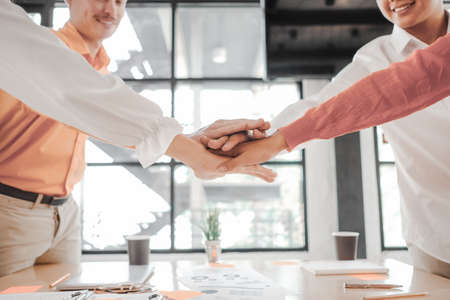 Businesspeople teamwork group putting their hands together agreement plan in meeting room, investment concept, success conceptの写真素材