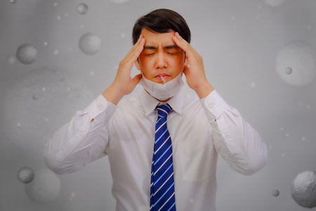 Asian man wear masks to protect PM 2.5 dust and air pollution and headache and sickness, air pollution concept, healthcare concept.の写真素材