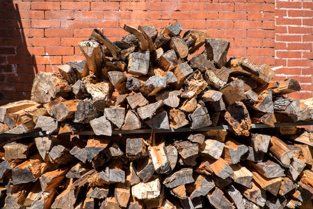 Stacked pile of wood with real brick in the background. On the streets of New York.の写真素材