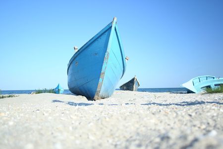 Fishing boat on the beach on a nice dayの写真素材