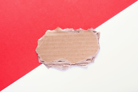 empty space for text made of cardboard on a red and white background close-upの写真素材