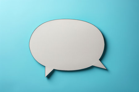 Silver circle with white outline that looks like speech bubble. Bubble is empty and background is blueの素材