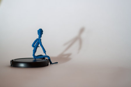 A simple yet striking composition with a blue skeleton figurine casting an interesting shadow....