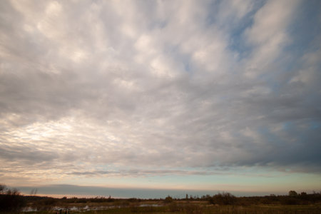 A beautiful and serene sky with clouds at sunrise or sunset.の写真素材
