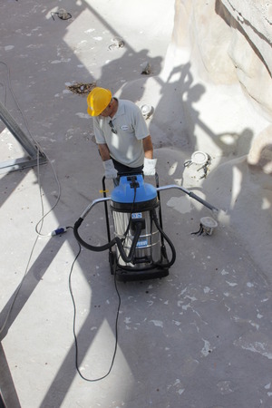 ROME, ITALY - 25 AUGUST 2014 - The Trevi Fountain. Cleaning and restoration of the most popular fountain in Rome. Workers collect coins from fountain.のeditorial素材