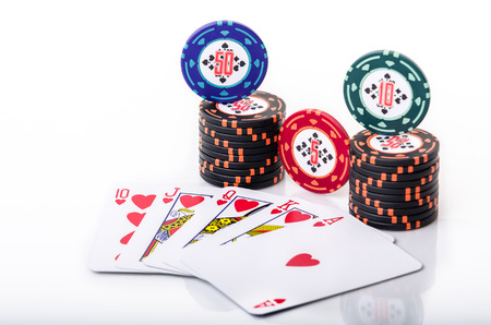Royal Flush with stacked poker chips on white background