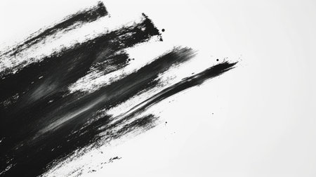 A thick, textured black paint brushstroke dramatically set against a pure white background.の素材