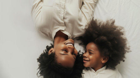 A mother and her child share an infectious laugh in a candid moment of pure joy.の素材