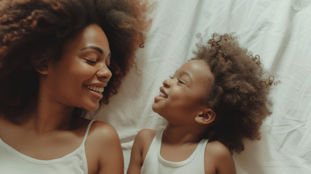 A mother and her child share an infectious laugh in a candid moment of pure joy.の素材