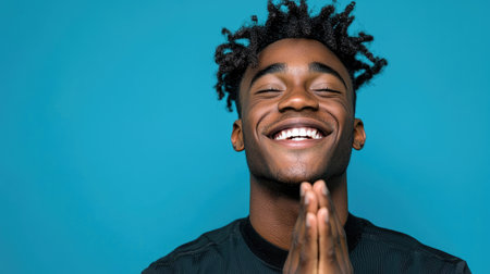 A vibrant portrait of a joyful African American male radiating positivity and confidence.の素材