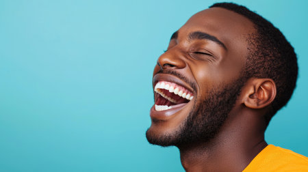 A vibrant portrait of a joyful African American male radiating positivity and confidence.の素材