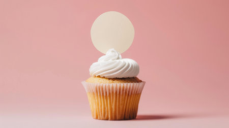 A delicious vanilla cupcake topped with creamy white frosting and a blank topper, perfect for custom messages or decorations.の素材